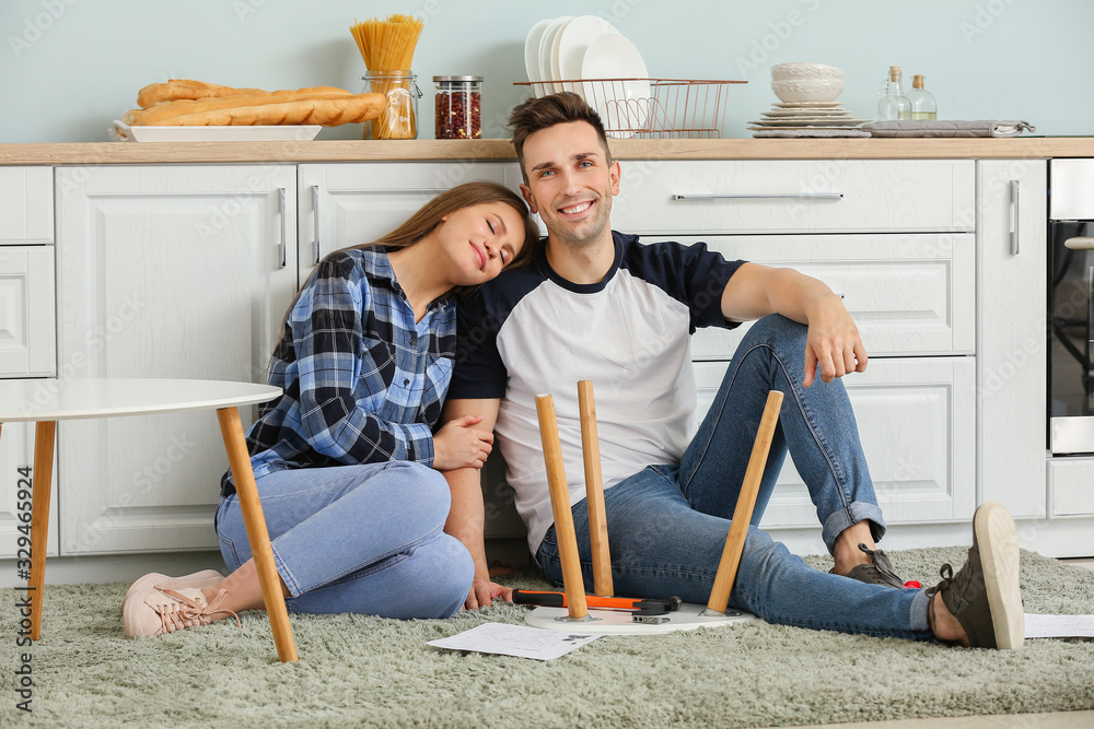 Young couple assembling furniture at home