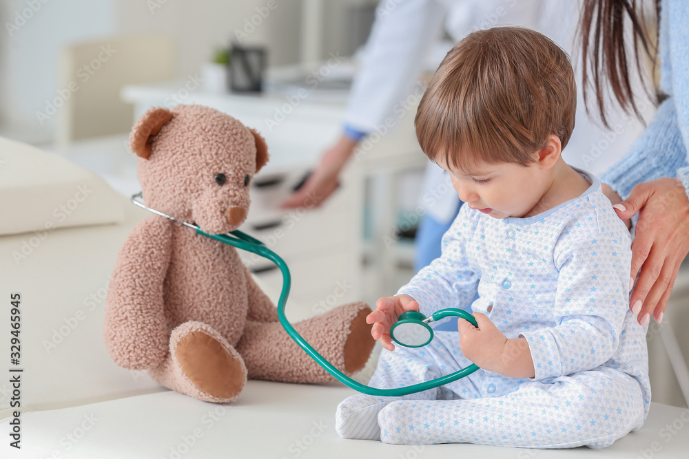 Woman with little baby visiting pediatrician in clinic