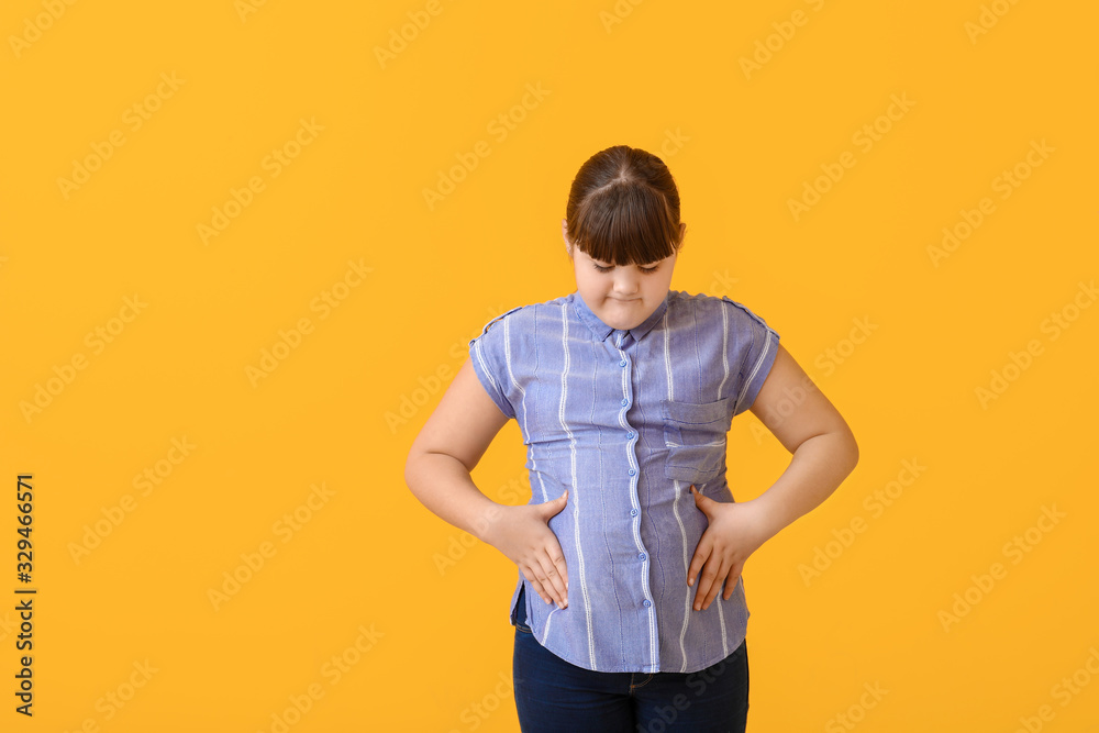 Sad overweight girl on color background