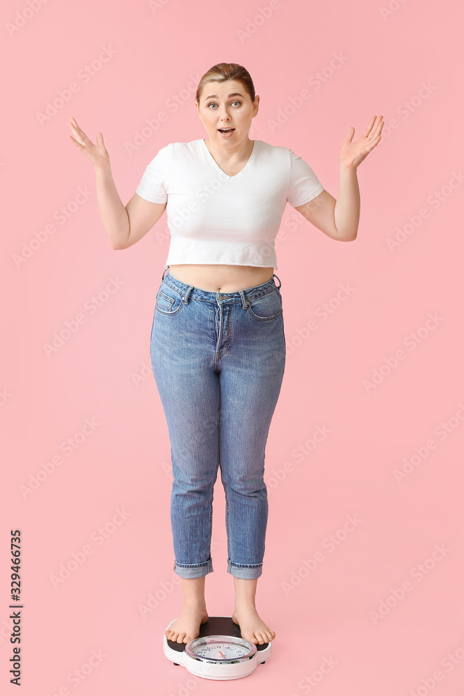 Overweight woman standing on scales against color background. Weight loss concept