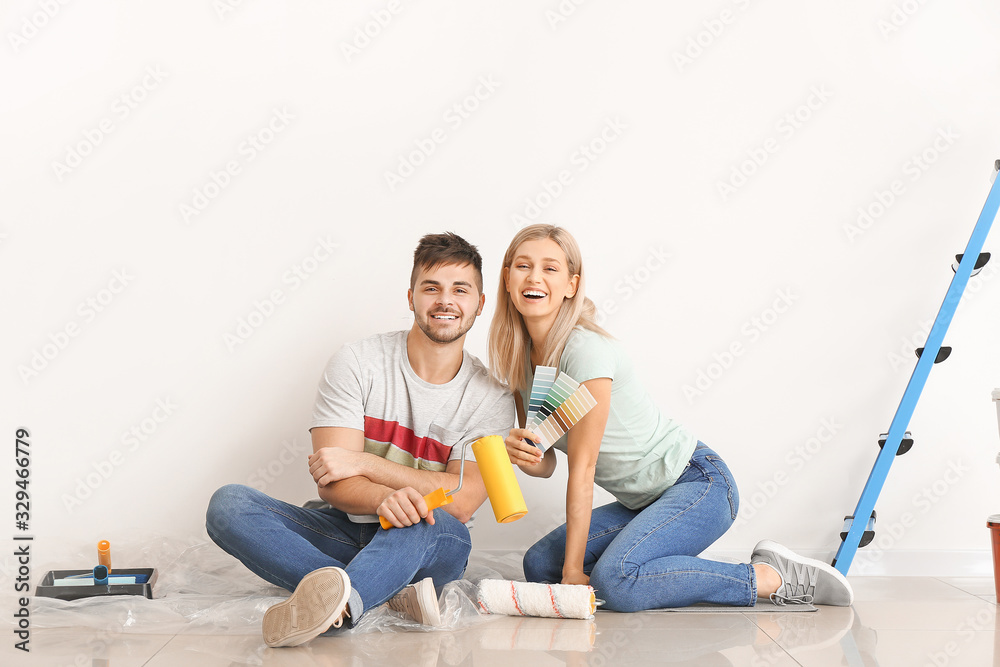 Young couple choosing color of wall