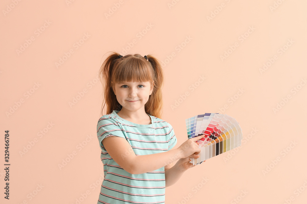 Little girl with color palettes on pink background