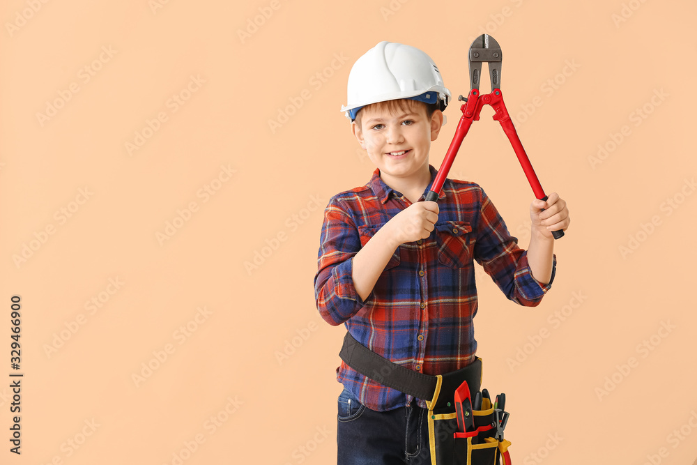 Cute little builder on color background