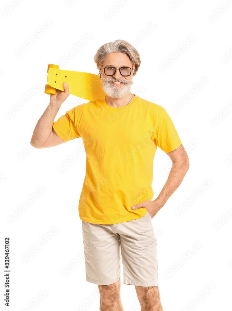 Stylish elderly man with skateboard on white background