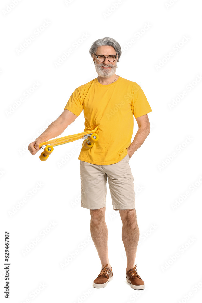 Stylish elderly man with skateboard on white background