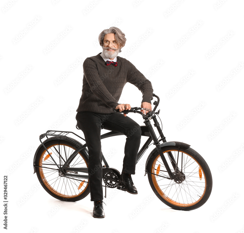 Stylish elderly man with bicycle on white background