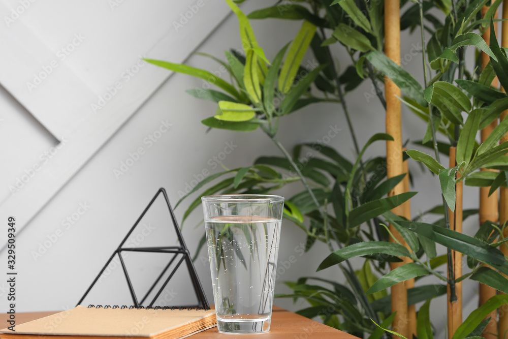 Glass of water on workplace in office