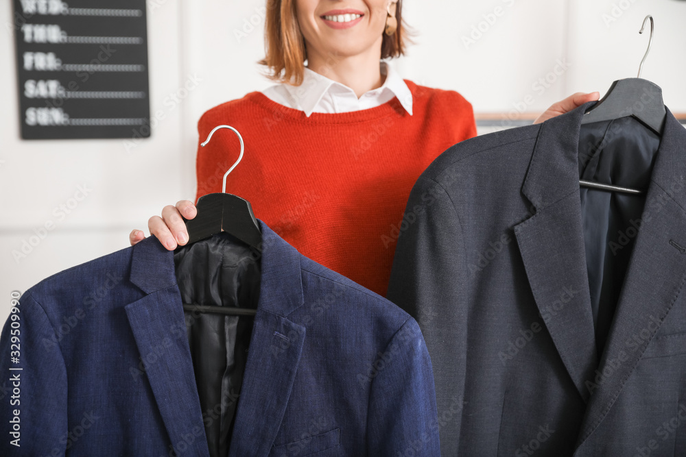 Female stylist with male clothes in her studio