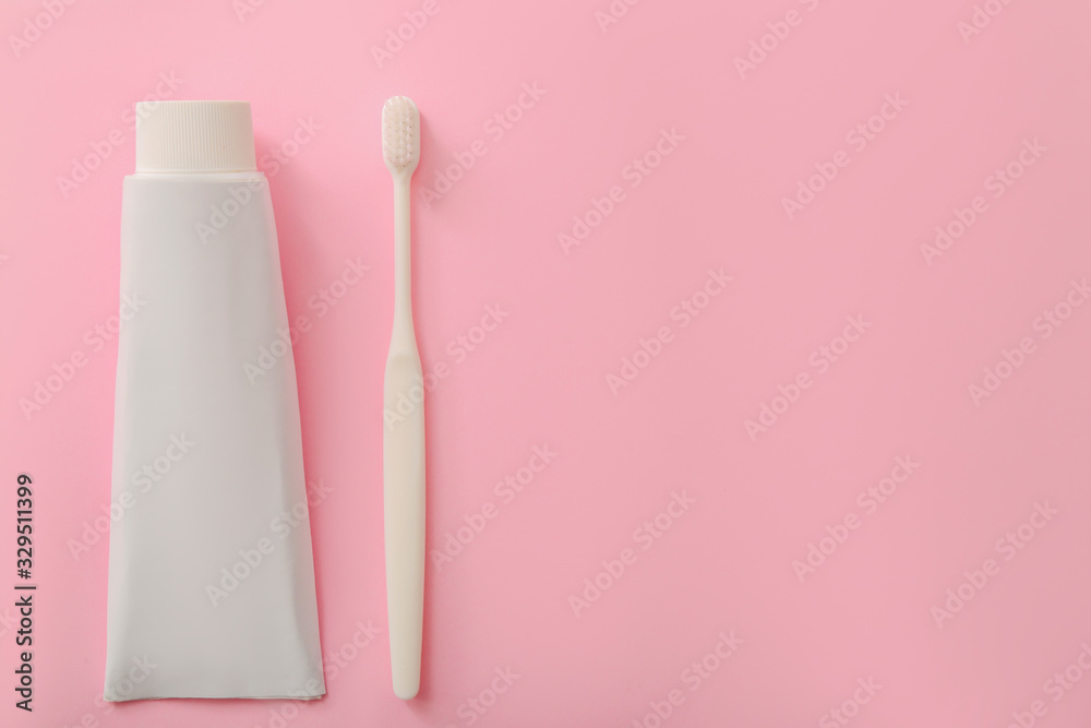 Tooth brush and paste on color background