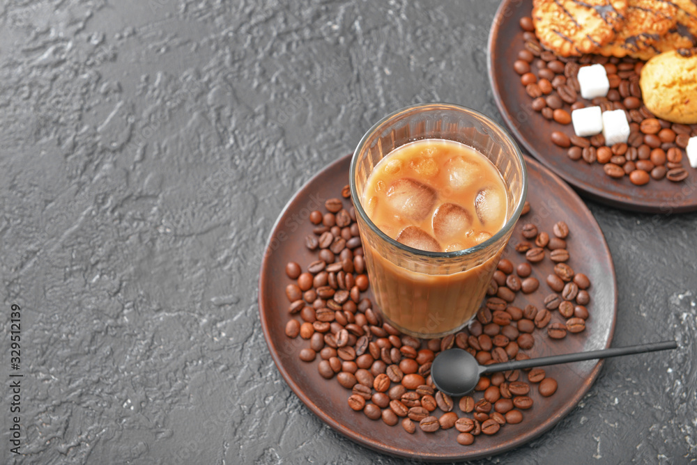 Glass of tasty iced coffee on dark background