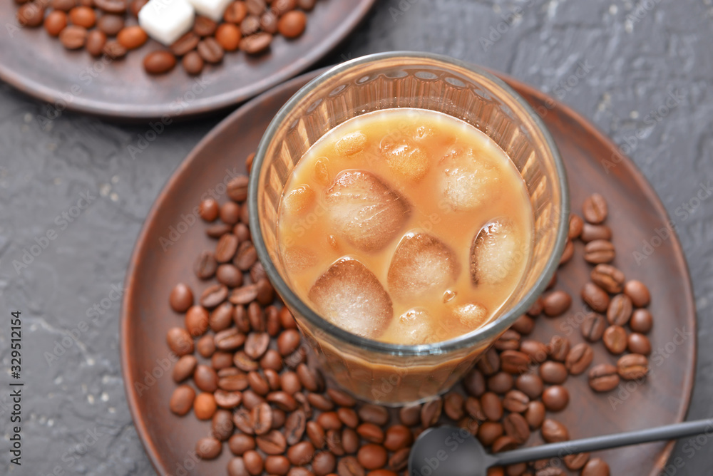 Glass of tasty iced coffee on table