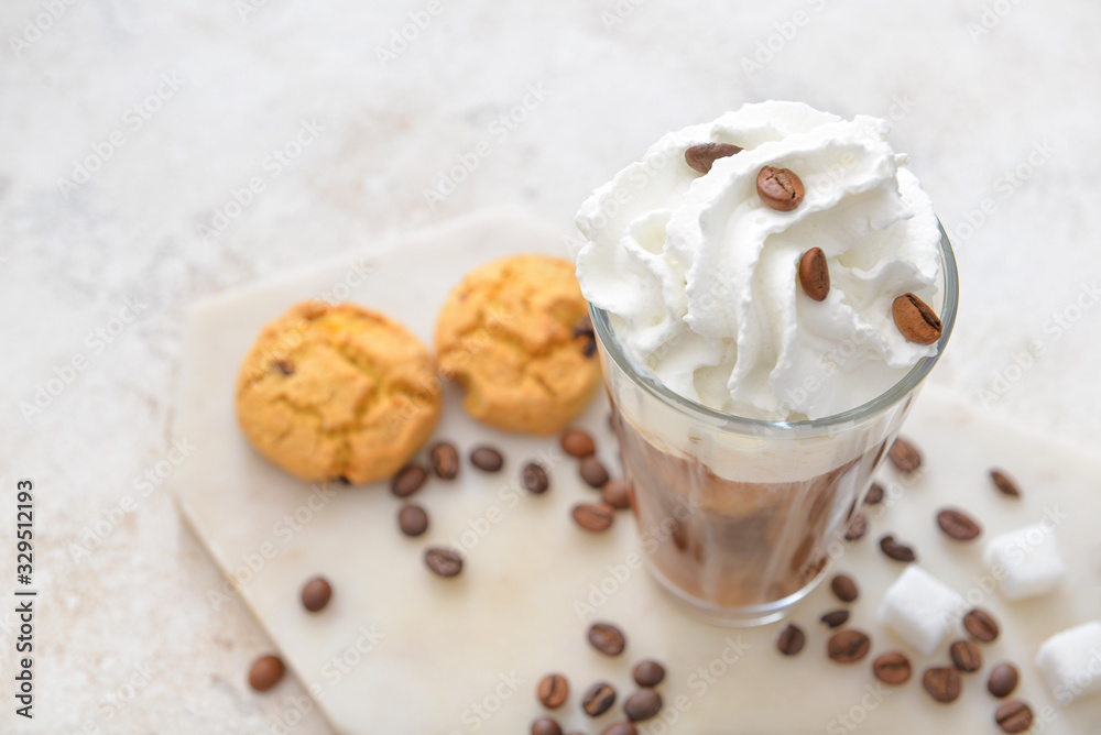 Glass of tasty iced coffee on table