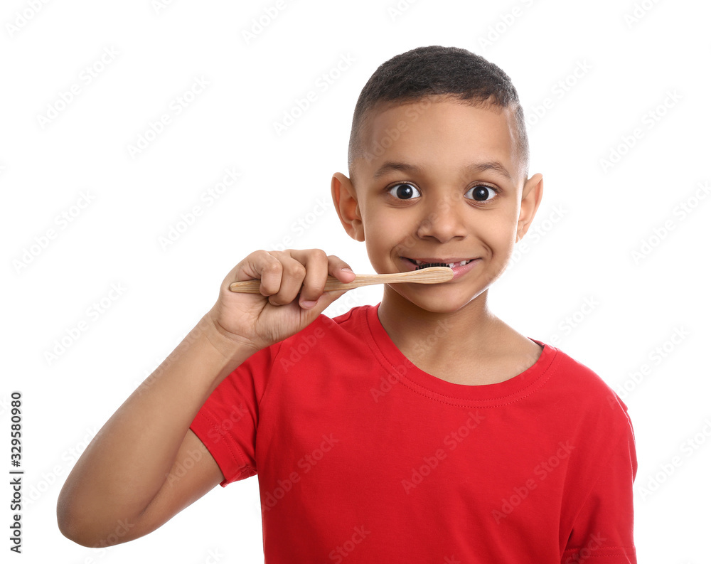 Little African-American boy with tooth brush on white background