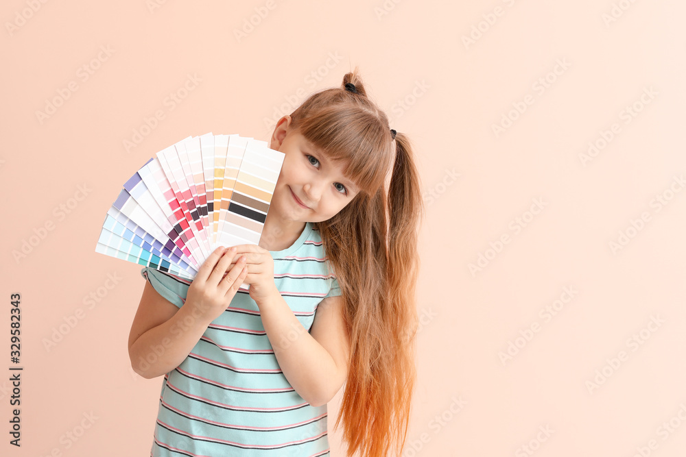 Little girl with color palettes on pink background