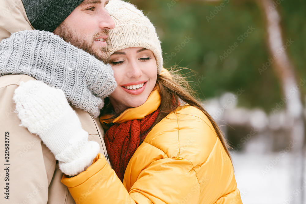 Happy young couple in park on winter day