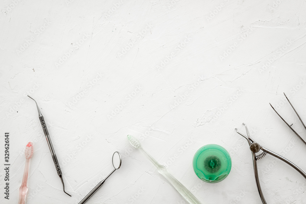 Dental care concept. Stomatological tools frame - with floss - on white background top-down frame co