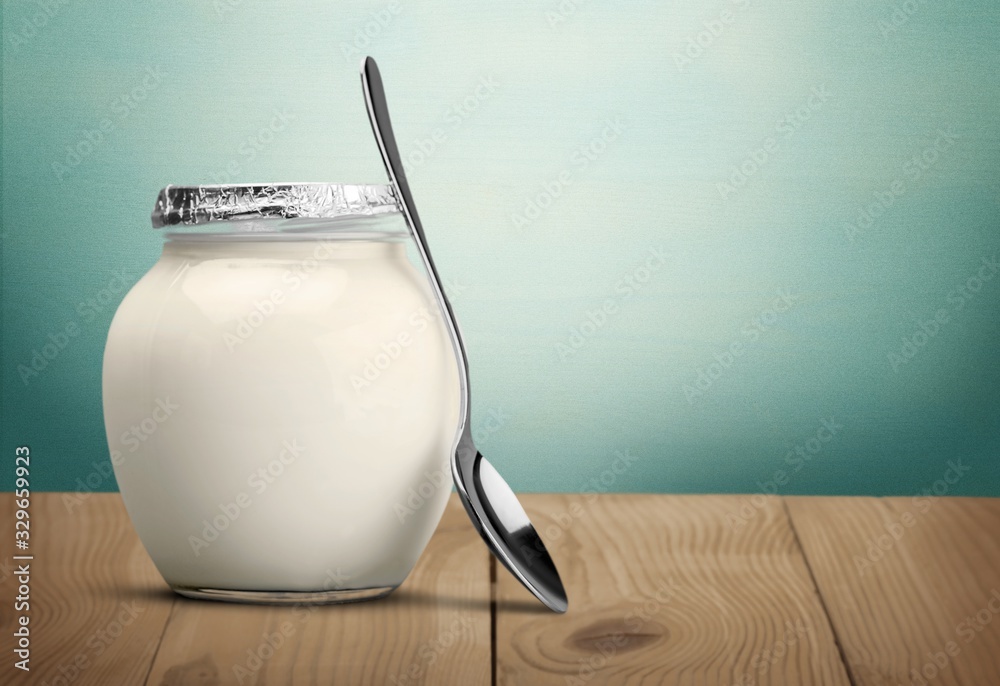 Glass jar of milk on wooden desk