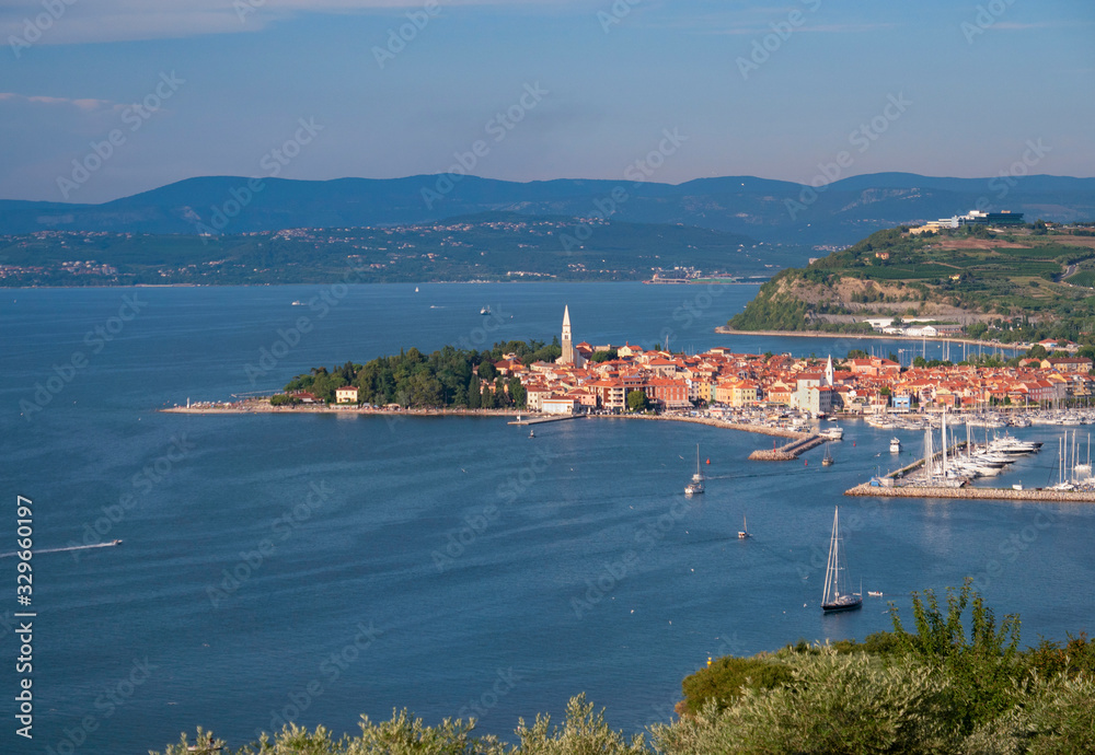 AERIAL: Flying away from harbor of a historic old town in the Adriatic sea.