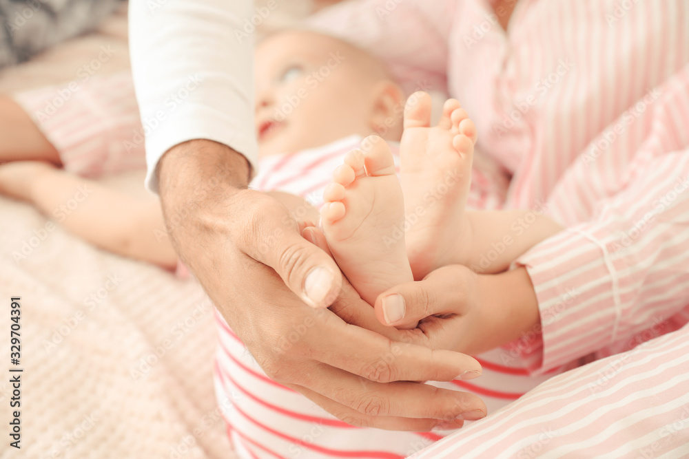 Cute baby with parents at home, closeup