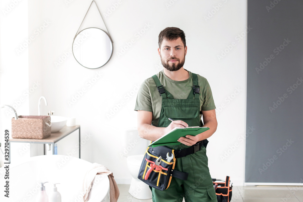 Portrait of plumber in bathroom