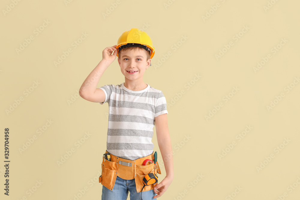 Cute little architect on light background