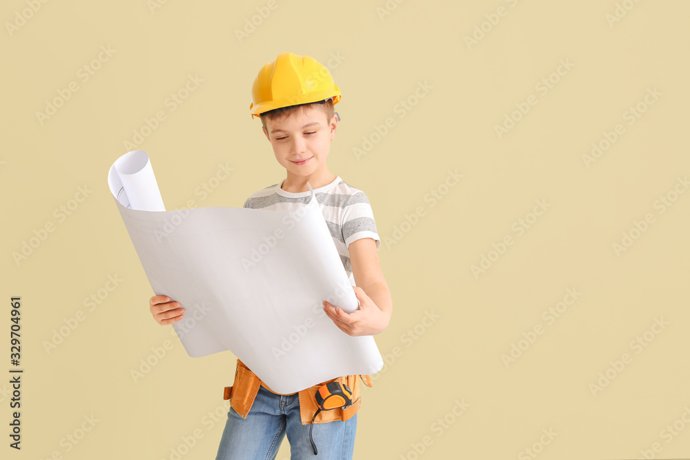 Cute little architect on light background