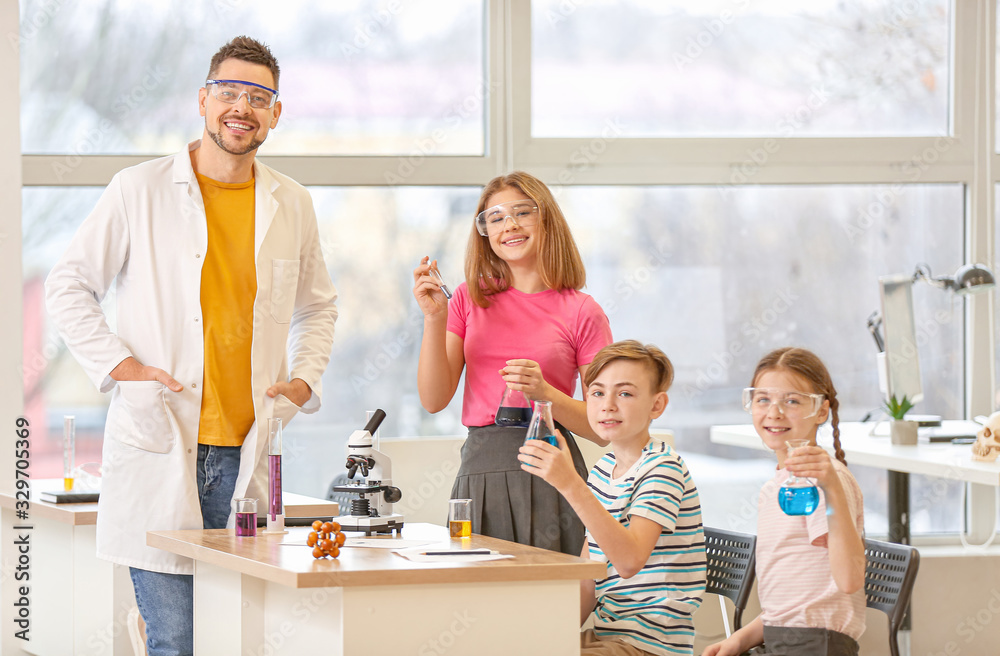 Teacher conducting chemistry lesson in classroom