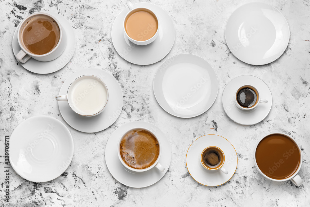 Composition with cups of different coffee on light background