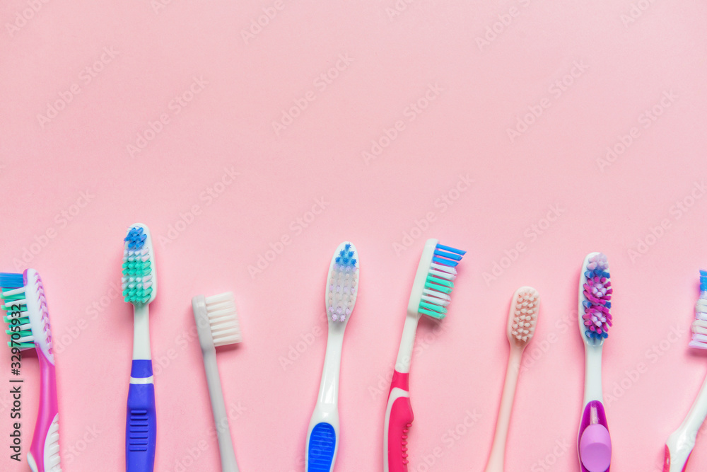 Tooth brushes on color background