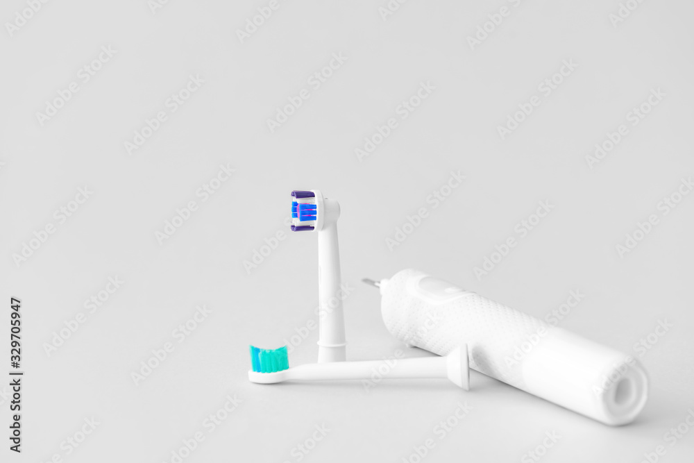 Electric tooth brushes on light background