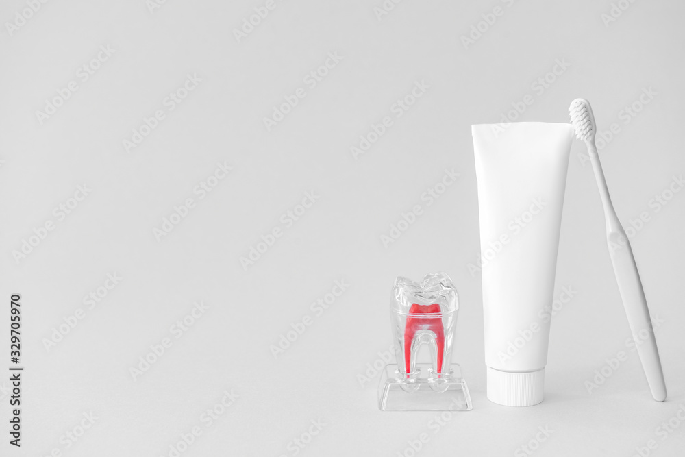 Tooth brush and paste on light background