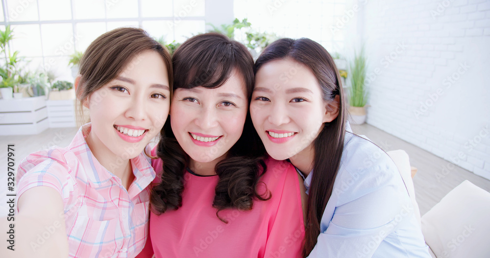 Daughters and mom take selfie