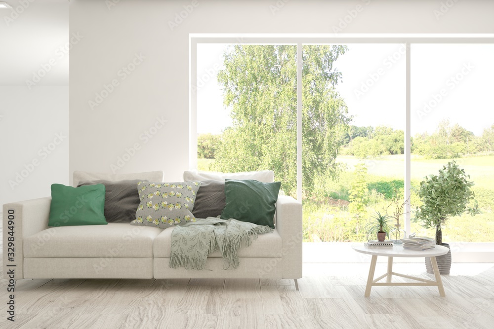 Minimalist living room in white color with sofa and summer landscape in window. Scandinavian interio