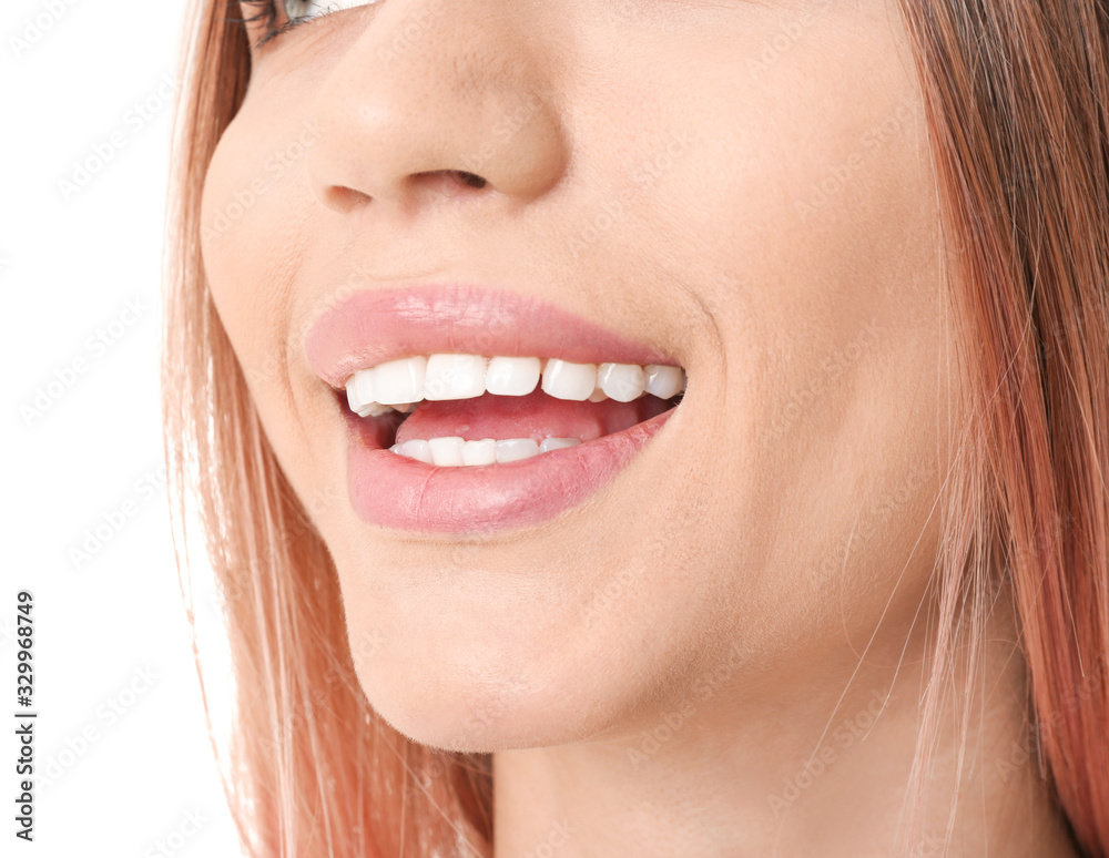 Young woman with healthy teeth on white background, closeup