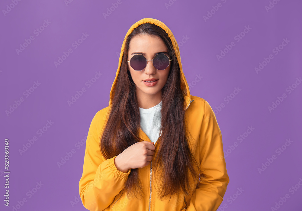 Stylish young woman on color background