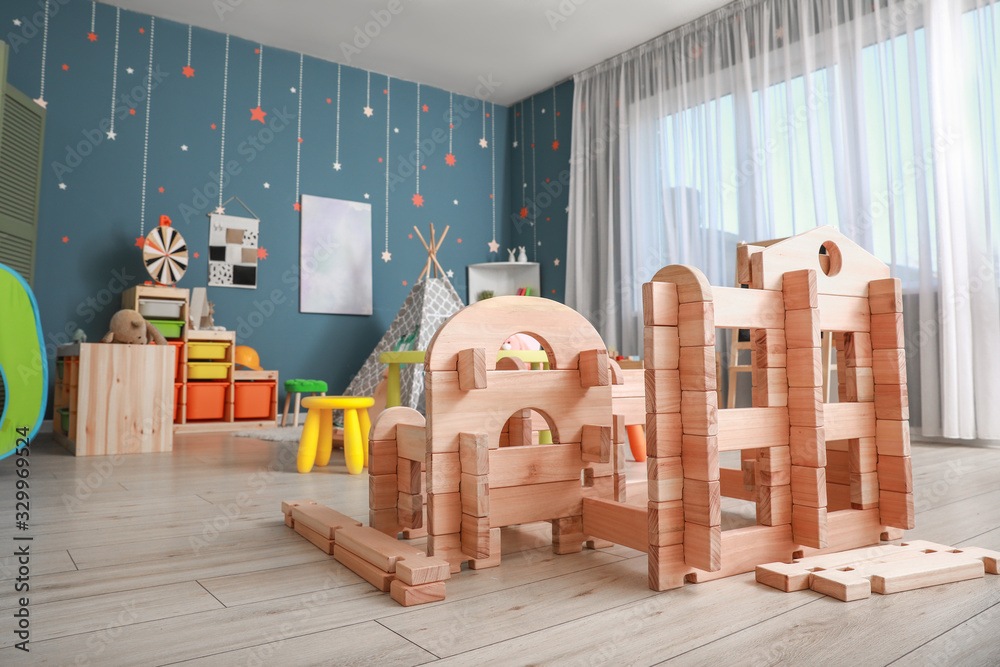 Wooden take-apart playhouse in childrens room