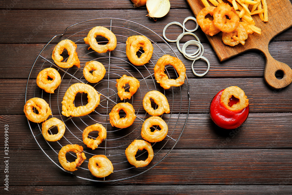 Composition with onion rings and french fries on table