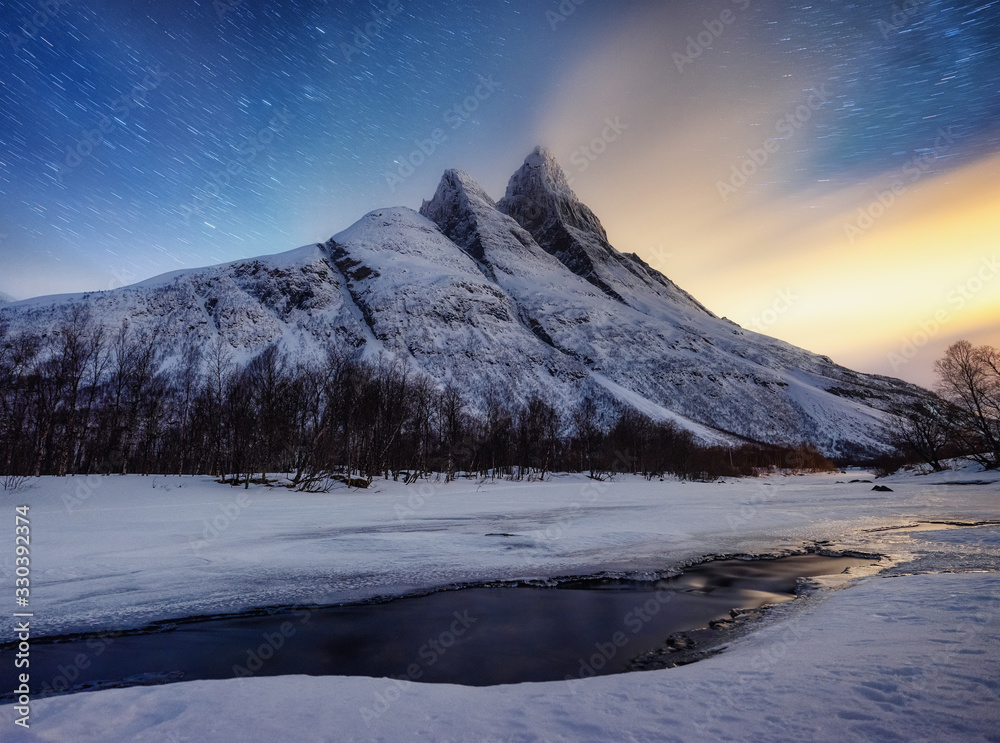 Mountains and starry night sky, Senja islands, Norway. Winter landscape with night sky. Norway trave