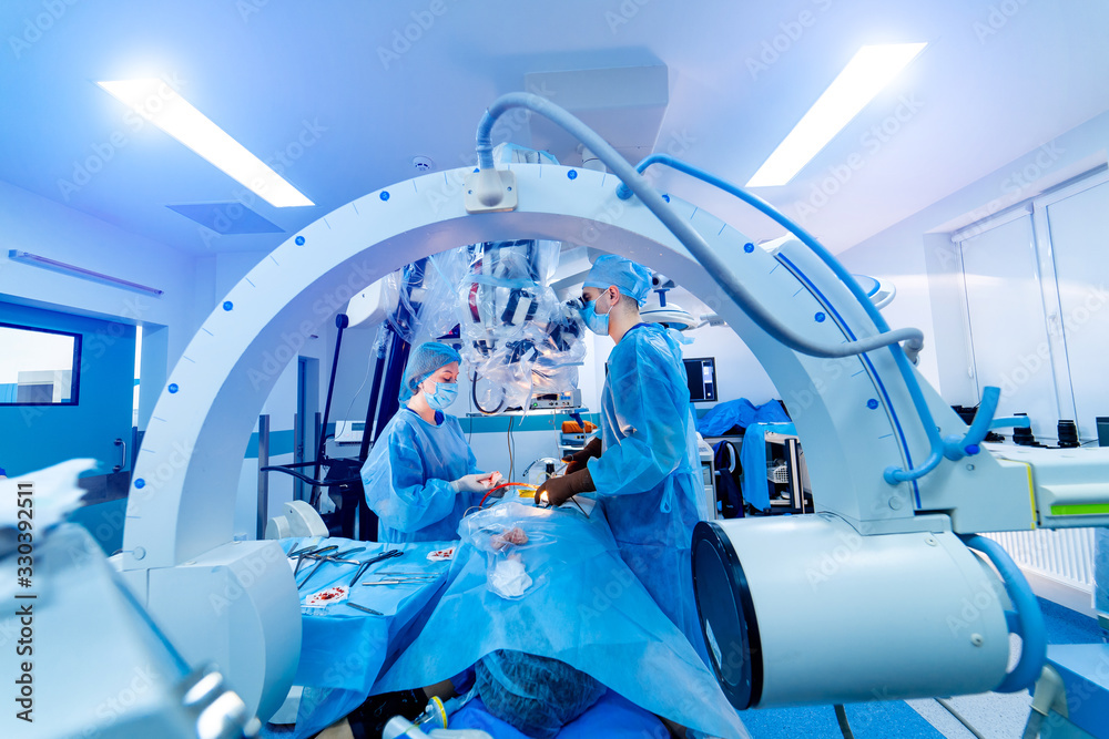 Manipulators performing surgery on a patient. Medical robot. Robotic Surgery. Medical operation invo