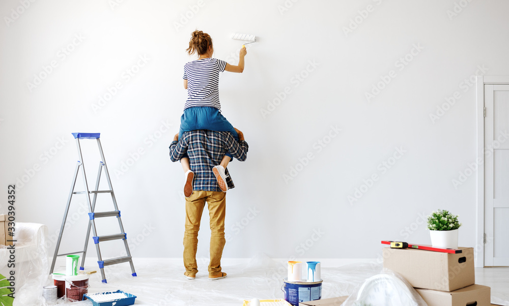 Anonymous  happy couple make renovating painting   wall at home.