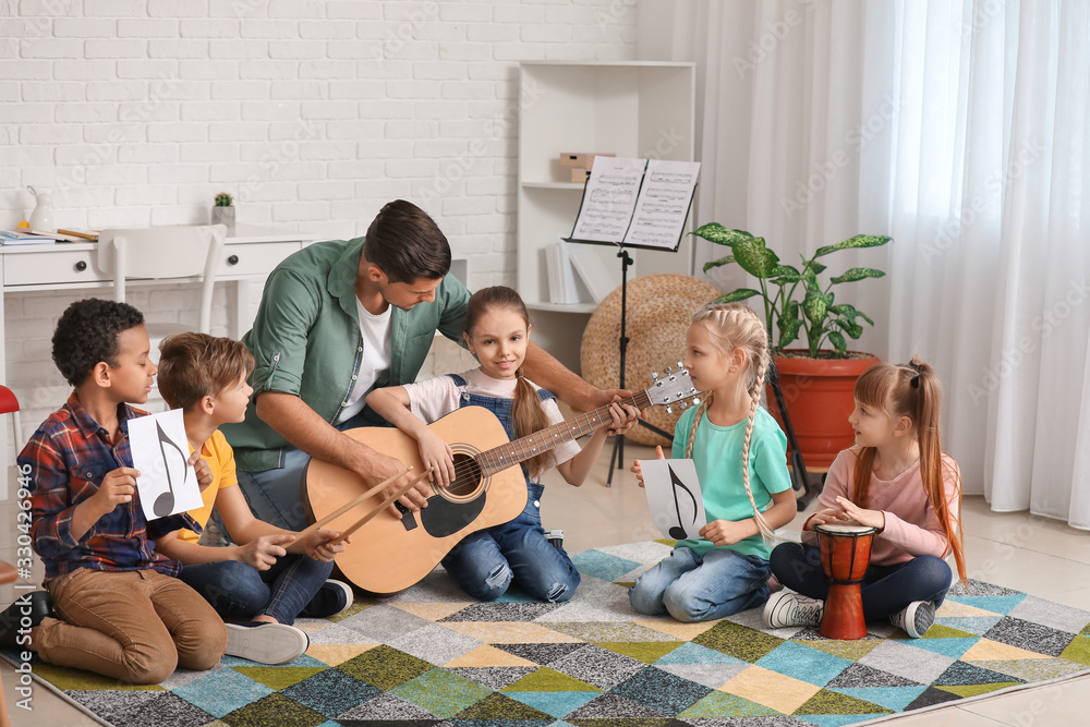 Teacher giving music lessons at school