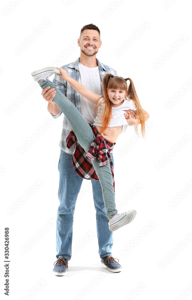 Father and his little daughter dancing against white background