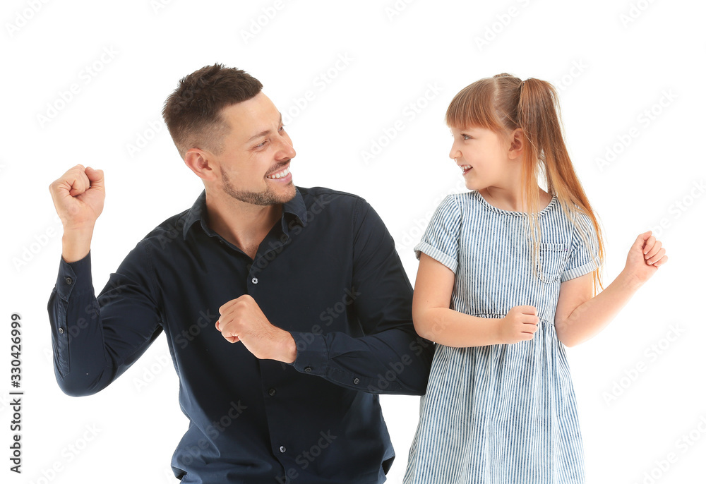 Father and his little daughter dancing against white background