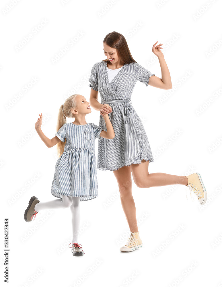 Woman and her little daughter dancing against white background