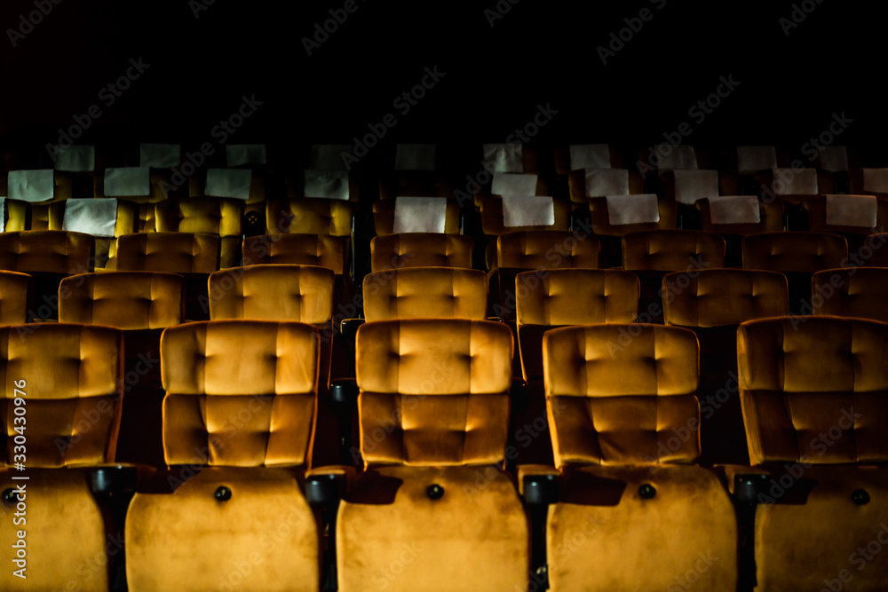 A row of yellow seat with popcorn on chair in the movie theater