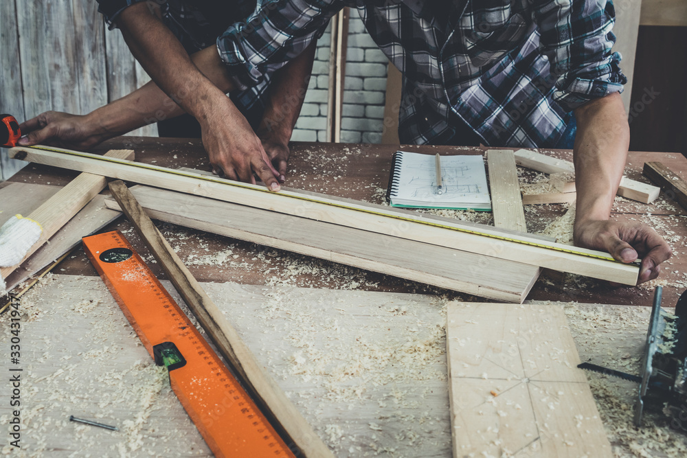 Carpenter working on wood craft at workshop to produce construction material or wooden furniture. Th