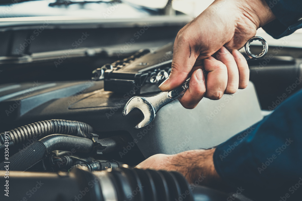 Professional mechanic providing car repair and maintenance service in auto garage. Car service busin