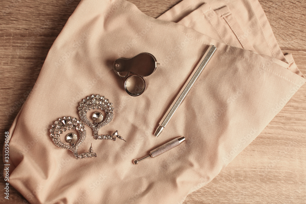 Jewelry earrings with tools on table in workshop