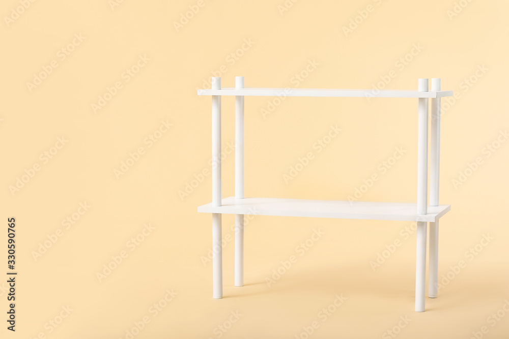 Empty shelving unit on color background