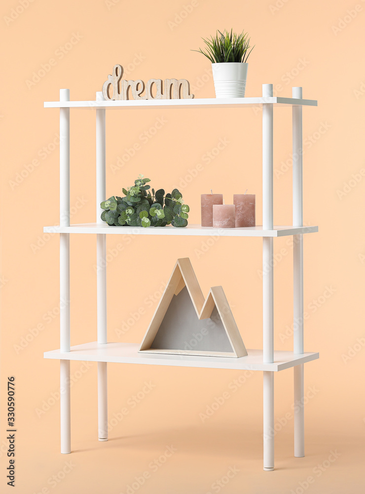 Shelving unit with decor on color background